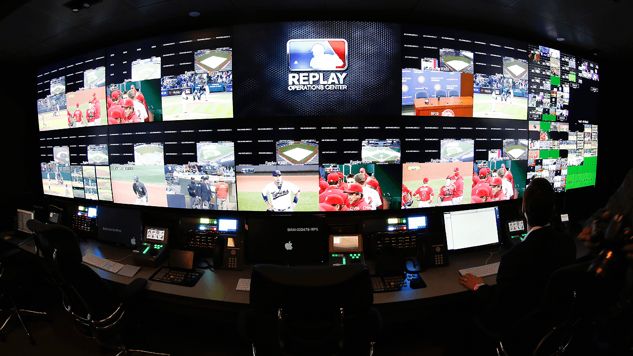 Replay operations center with multiple live sports feeds across a curved wall
